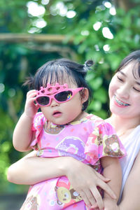 Young woman wearing sunglasses while standing outdoors