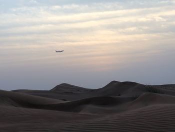 View of sand dunes against sky