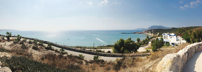 Panoramic view of sea and buildings against sky