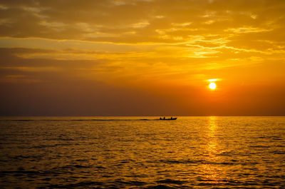 Scenic view of sea against orange sky