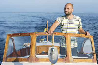 Mid adult man in boat, sweden