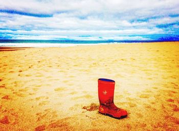 Scenic view of sandy beach against blue sky