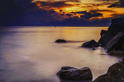 Scenic view of sea against dramatic sky