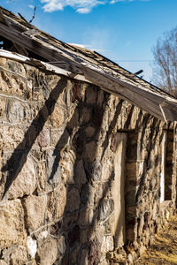 Low angle view of old stone bathhouse building against sky