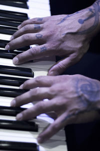 Close-up of hands playing piano