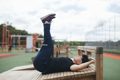 Young woman exercising at outdoor gym