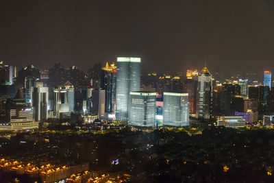 High angle view of illuminated buildings against sky at night