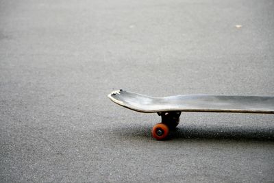 Close-up of skateboard on road