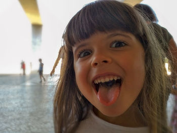 Portrait of cute girl sticking out tongue