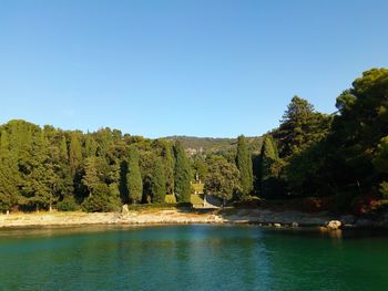 Scenic view of lake against clear blue sky