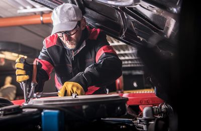 Man repairing car in shop