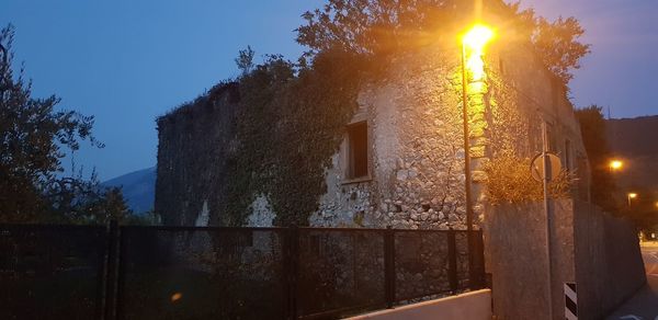 Low angle view of illuminated building against sky at dusk