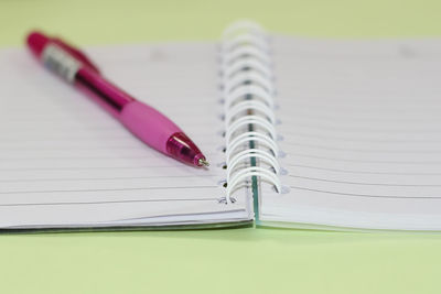 Close-up of pen and notebook on table