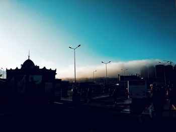 Street amidst buildings against sky at dusk