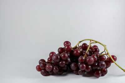 Close-up of grapes over white background