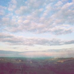 Scenic view of landscape against cloudy sky