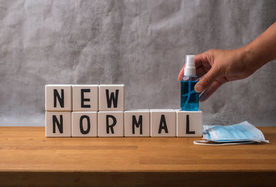 Midsection of person holding umbrella on table