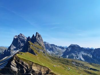 Scenic view of mountains in summer against blue sky