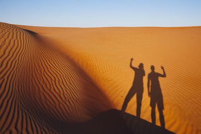 Shadow of people on desert