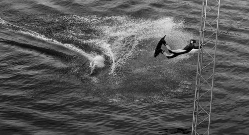 Man enjoying kiteboarding on platform in sea