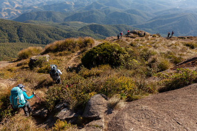 People on landscape against mountains