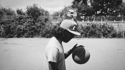 Woman standing on tree trunk