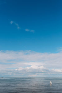 Scenic view of sea against blue sky