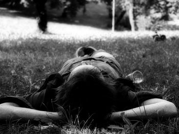 Woman lying on field at park