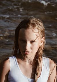 Close-up portrait of girl standing in sea