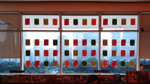 Multi colored building by train