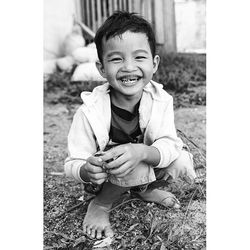 Portrait of cute boy standing on grass