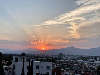 High angle view of buildings against sky during sunset