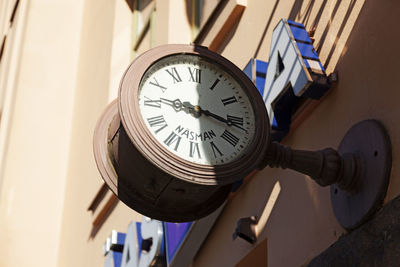 An old clock with an unusual mark above a store