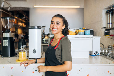 Portrait of smiling woman working at cafe