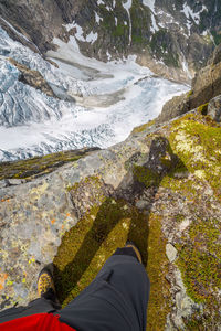 Low section of person standing on rocks