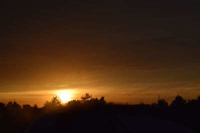 Silhouette trees against sky during sunset