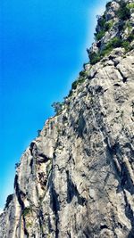 Low angle view of rock formation against blue sky