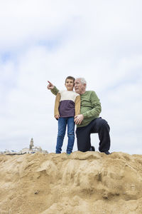 Little boy and his grandfather spending time on the beach