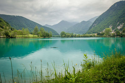 Scenic view of lake and mountains against sky