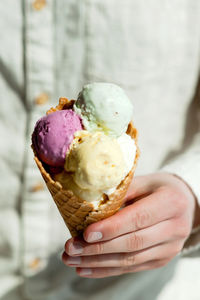 Close-up of hand holding ice cream