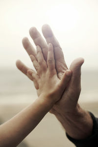 Girl doing high-five with grandfather