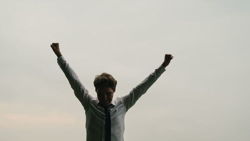 Low angle view of man standing against sky