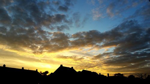 Low angle view of silhouette trees against sky at sunset