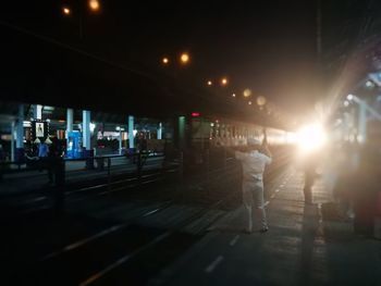 People at railroad station at night