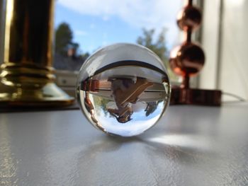 Close-up of crystal ball on glass