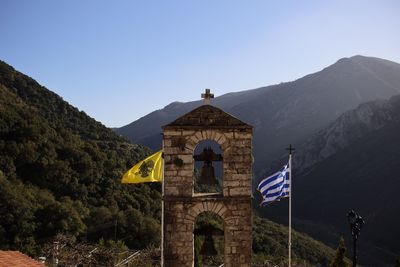 View of bell tower and mountain against sky