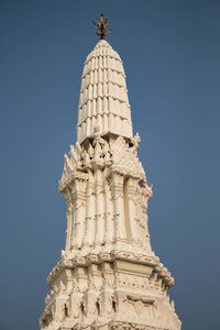 Low angle view of statue against blue sky