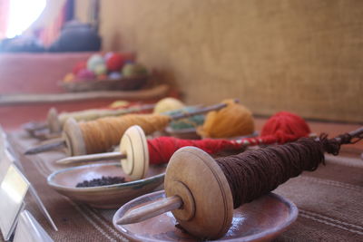 Colorful spools of wool on table