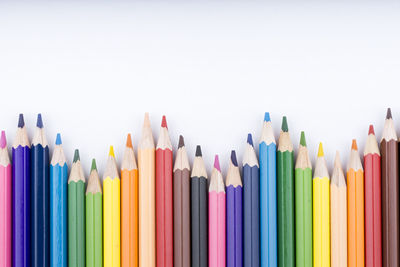 Close-up of colored pencils against white background