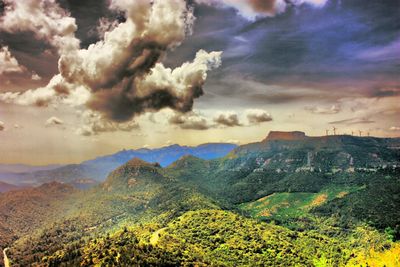 Scenic view of mountains against cloudy sky